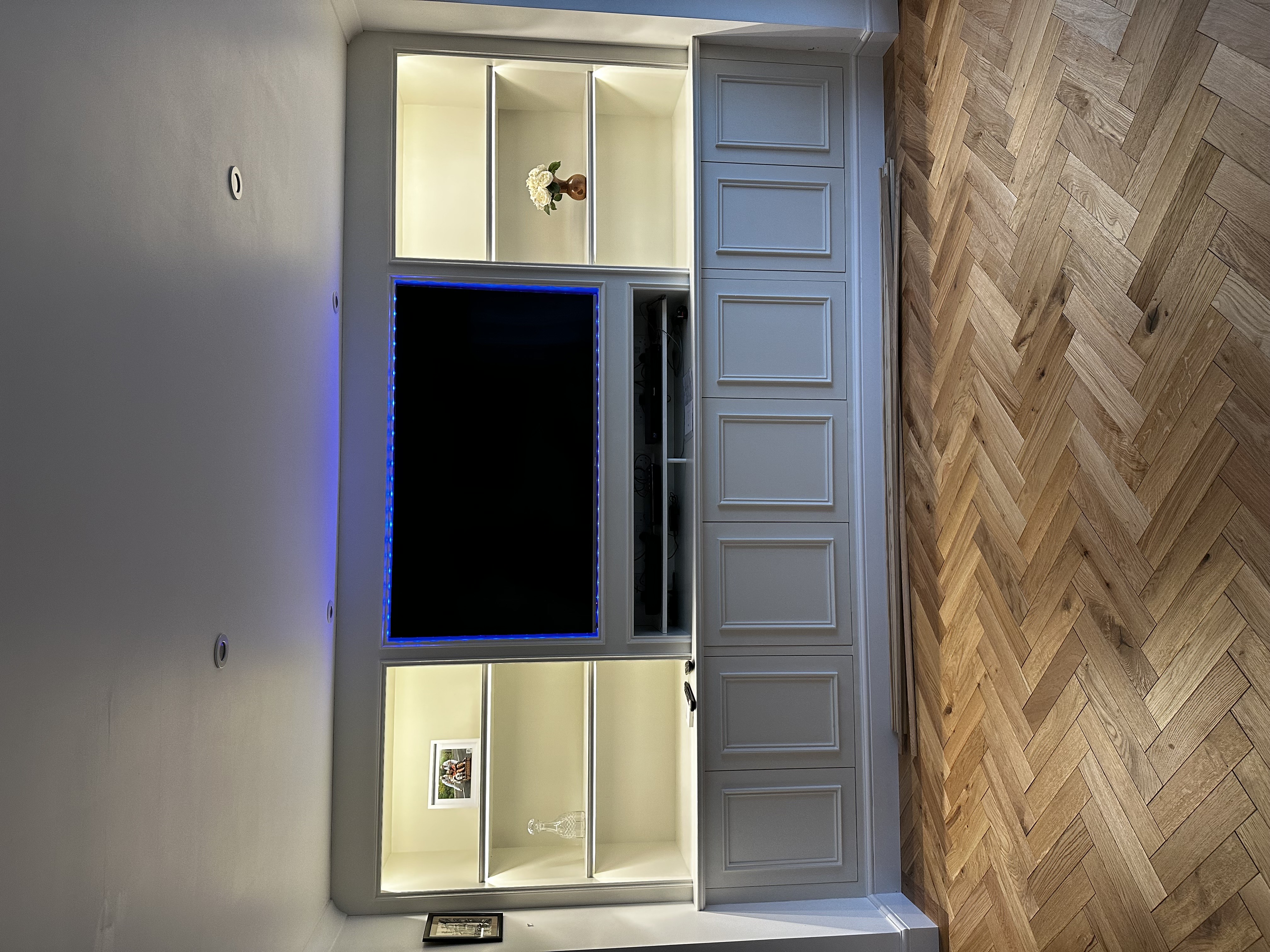 Bespoke built-in media wall with LED shelving