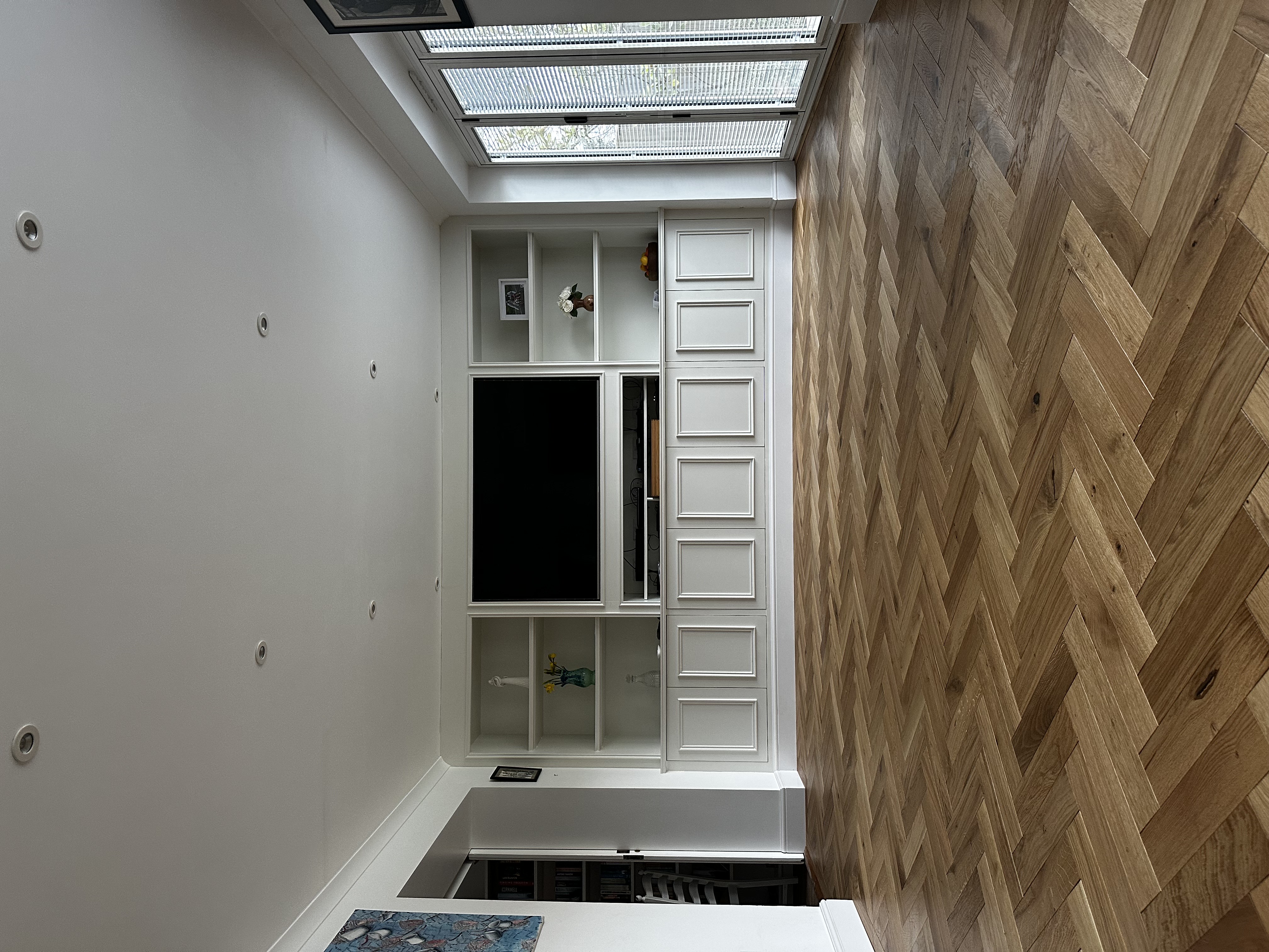 Bespoke media wall with herringbone oak floor