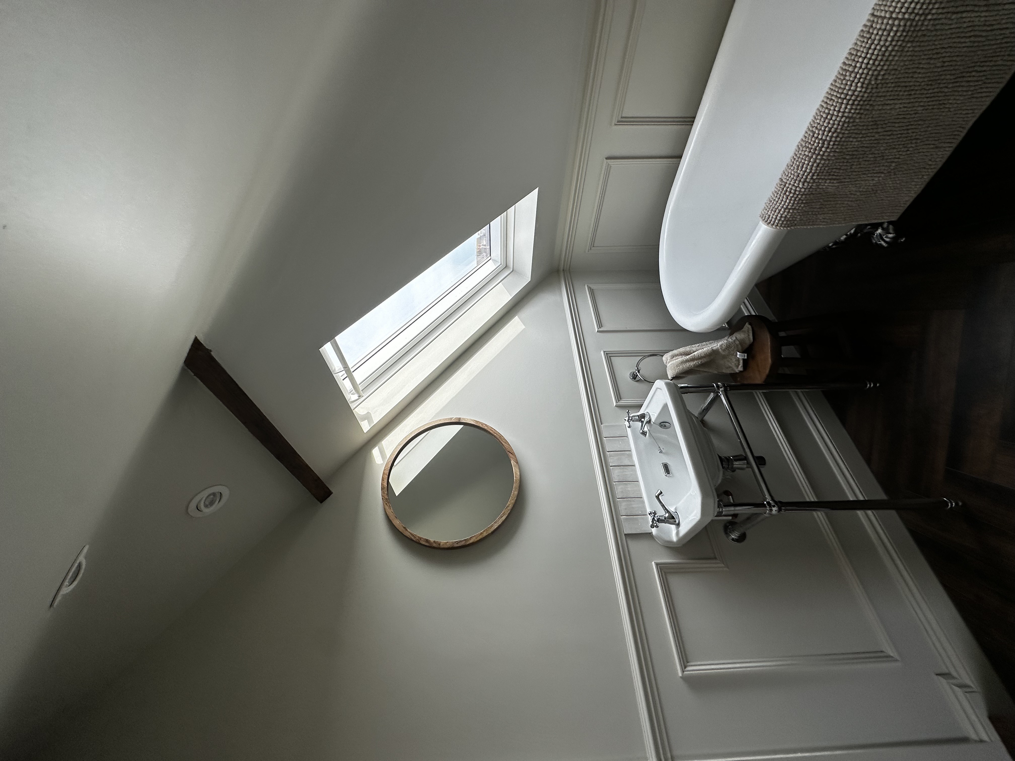 Attic bathroom with bespoke panelling and clawfoot bath